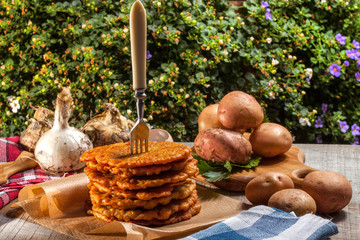 Potato pancake on a wooden table.