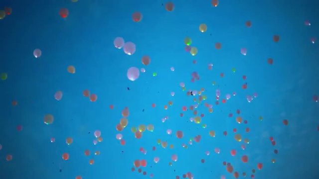 Blinking helium balloons flying up to the sky 