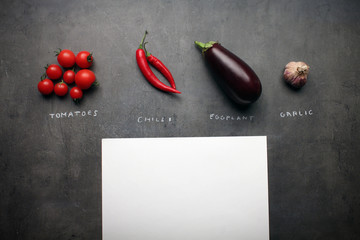 Fresh vegetables with chalky signs and white paper with space for your recipe text
