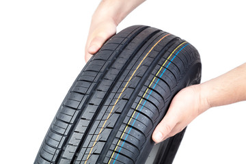 Car tire in the hands on white background.