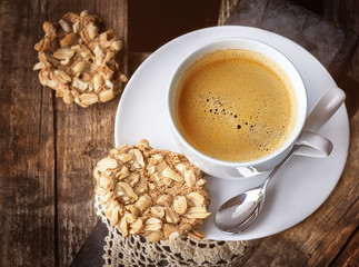 Tasty meringue cakes with nuts and cup of coffee
