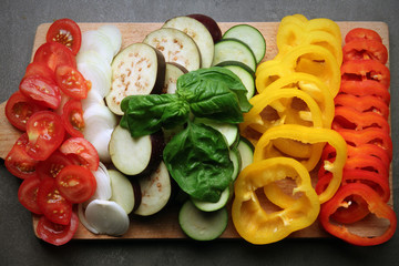 Chopped vegetables on wooden cutting board closeup