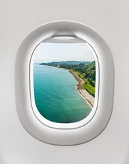 Looking out the window of a plane to the sea shore in Batumi