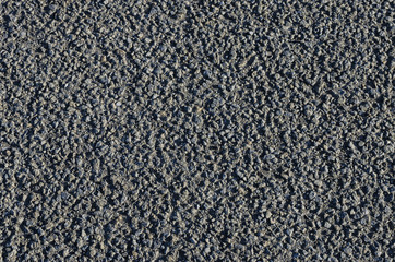 Abstract close up of a road surface, suitable for use as a background or texture.