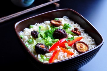 ramen noodles with shiitake mushrooms, green peas, sweet pepper and coriander