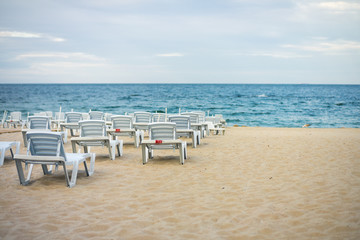 Lots of empty chairs on a deserted beach