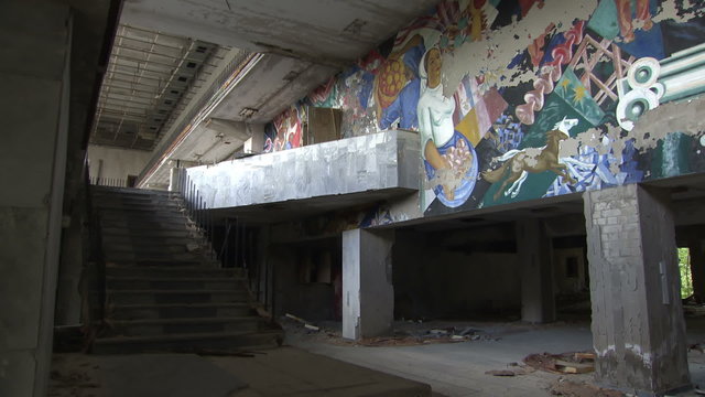 Soviet-era murals on the wall in the House of Culture "Energetic" in the dead city of Pripyat. Ghost town in the Chernobyl zone.