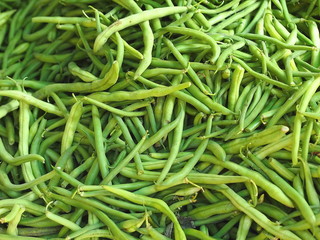 Pile of fresh green bean legume (hull) at farmers market stall.