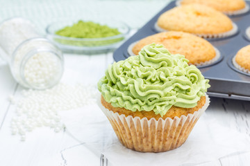 Healthy muffins with ricotta cheese and matcha frosting