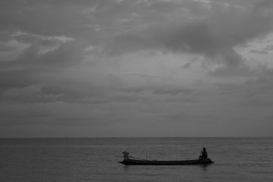 Small fishing boat on sea water ;  black & white style