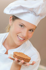 Baker holding a chocolate dessert