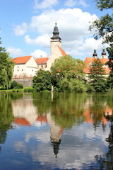 Fototapeta na wymiar fairy tale castle and its mirror image on the surface of the pond, Telc, Moravia, Czech republic