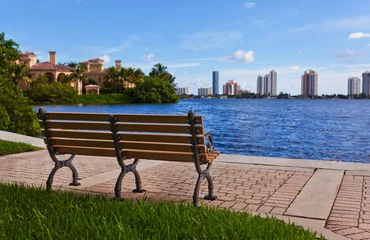 Fotobehang Wooden bench beautiful view on the sea and city © Carlos Yudica