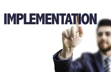 Businessman pointing the text: Implementation