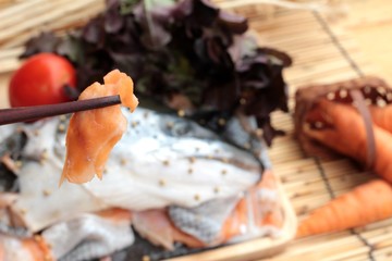 Salmon head for cooking and fresh salmon fillets .