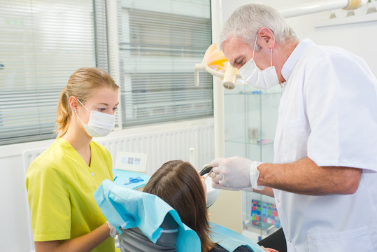 Busy dentist with a patient