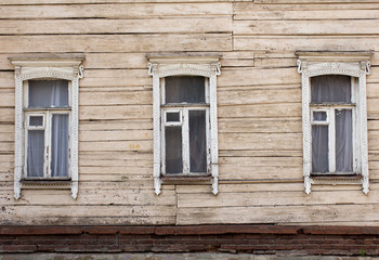 Fototapeta na wymiar three windows decorated with carved aprons