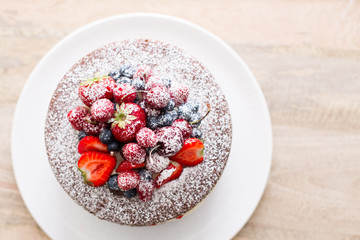 Homemade cake with fresh berries on the top.