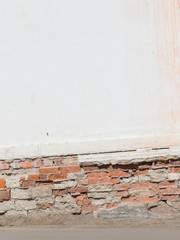 old white wall with bricks and floor