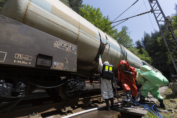 Fototapeta na wymiar Toxic chemicals acids emergency team near train