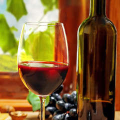 Red wine in glass and bottle