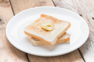Slice of bread toast on a white plate.