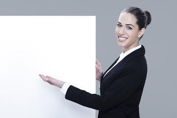 Woman pointing at a blank board