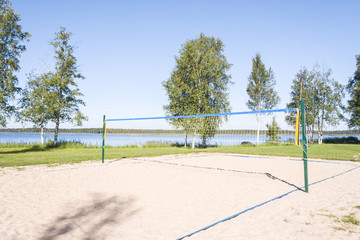 Sandy volleyball field at a lake coast