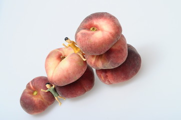 Flat peaches on light background