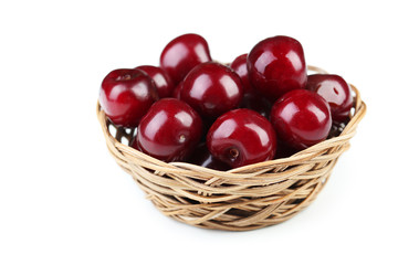 Ripe cherry in basket on white background