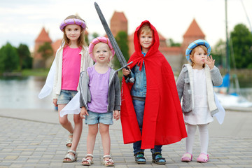 Three princesses and a knight having fun outdoors