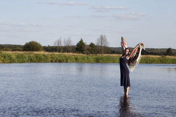 Fototapeta na wymiar Modest girl posing in the water.