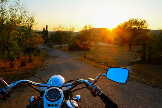 motorcycle on the edge of the road at sunset