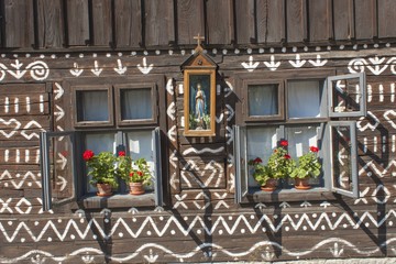 Old wooden window. Unique decoration of log houses based on patterns used in traditional embroidery in village of Cicmany, UNESCO World Heritage Site, Slovakia

