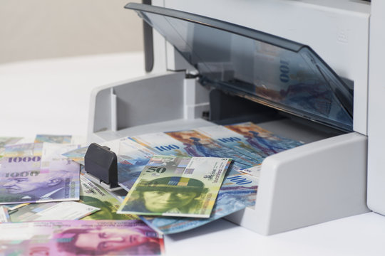 Printer printing fake Swiss francs, currency of switzerland