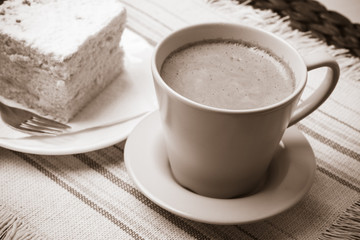 cup with coffee and cake on table