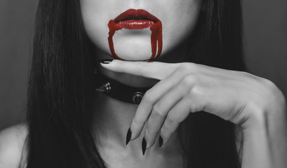 Fototapeta premium Red lips of vampire in the blood