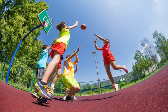 Fisheye view of teenagers playing basketball game