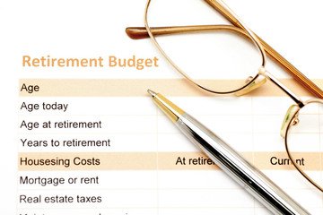 retirement plan document with pen and glasses