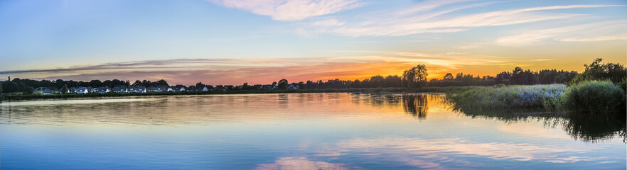 Obraz premium sunset in Zinnowitz with reflection of the backwater