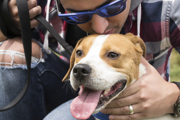 Close-Up of Dog Lover Giving His Pet A Kiss 