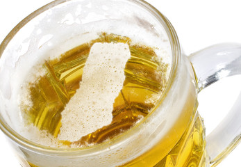 Beer head shaped as Ghana in a beer mug.(series)