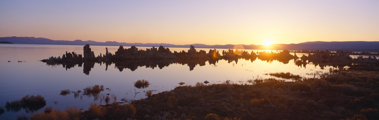 Tufa rock formations emerging from Mono Lake at sunrise, California