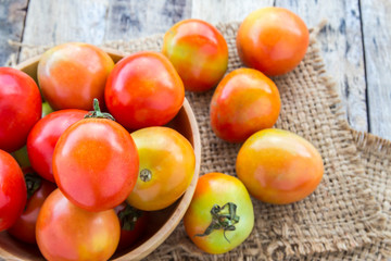Fototapeta na wymiar Fresh tomatoes on wooden table