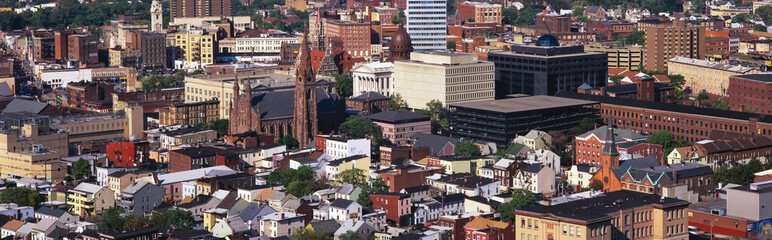 This is a congested urban landscape. It shows the elements of life of church, work, and home within the city limits.