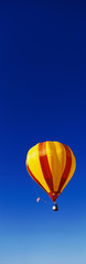 Fototapeta premium This is the 25th Annual Albuquerque International Balloon Fiesta. It shows a red and yellow balloon that is part of the mass ascension of colorful balloons.
