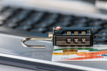 combination lock with credit card on laptop