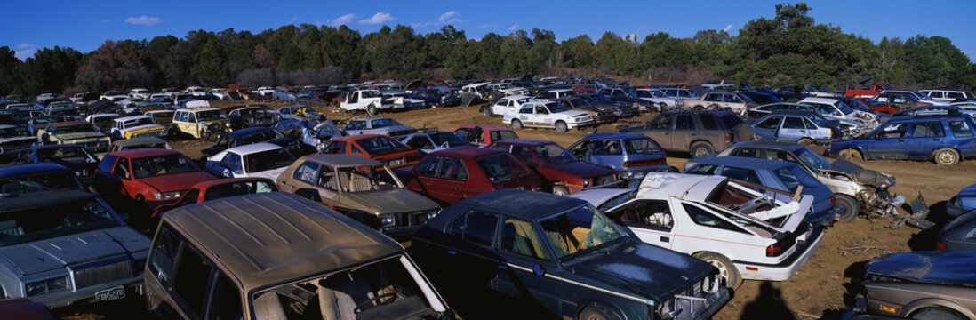 This Is An Auto Salvage Yard. The Cars Here Are Either Crashed Vehicles Or No Longer In Use. They Are Wrecks All Parked Side By Side.