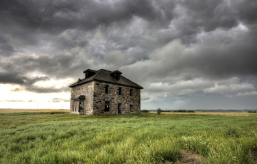 Fototapeta na wymiar Storm Clouds Prairie Sky stone house