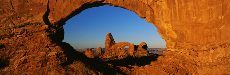 This is known as Turret Arch which is in the center. It looks through what is known as the North Window. It is located in the Windows Section.  This was taken at sunrise. © spiritofamerica